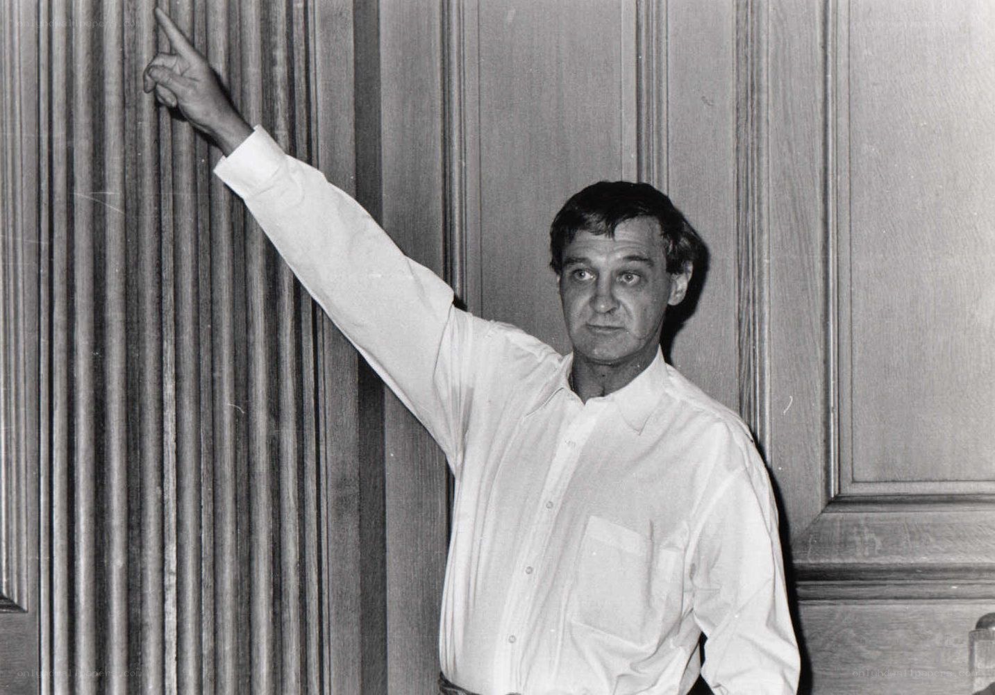 man pointing at wall
