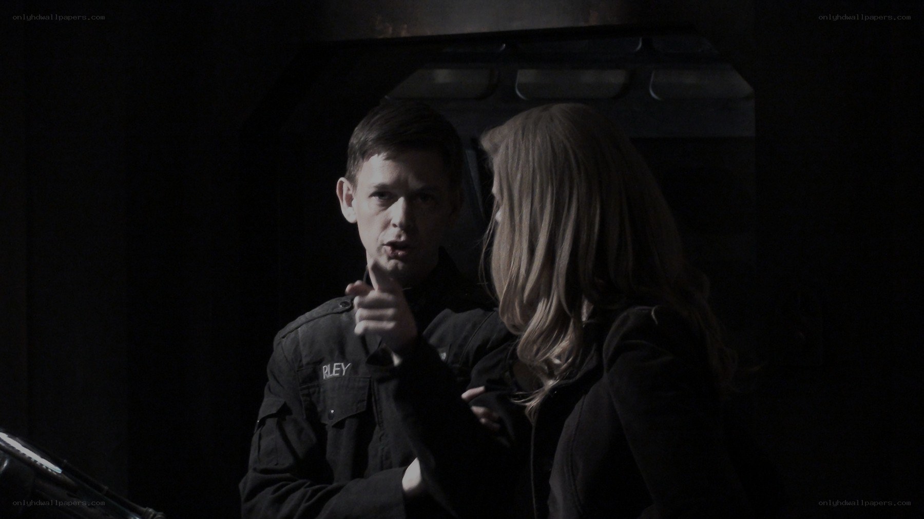 man pointing at woman