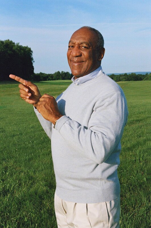 man pointing in a field