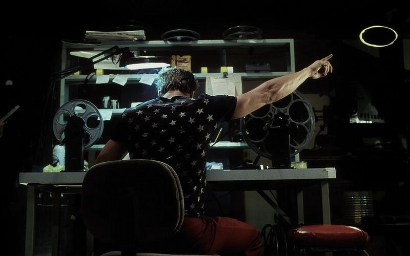 man pointing in dark room