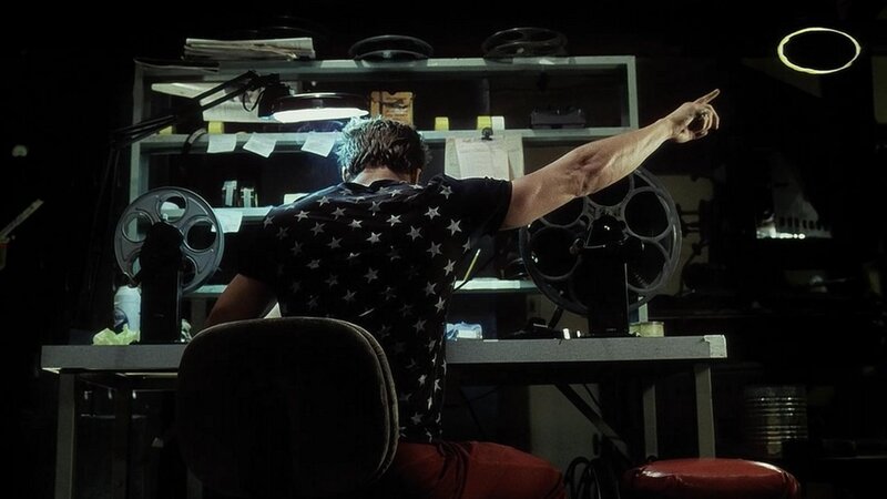 man pointing in dark room