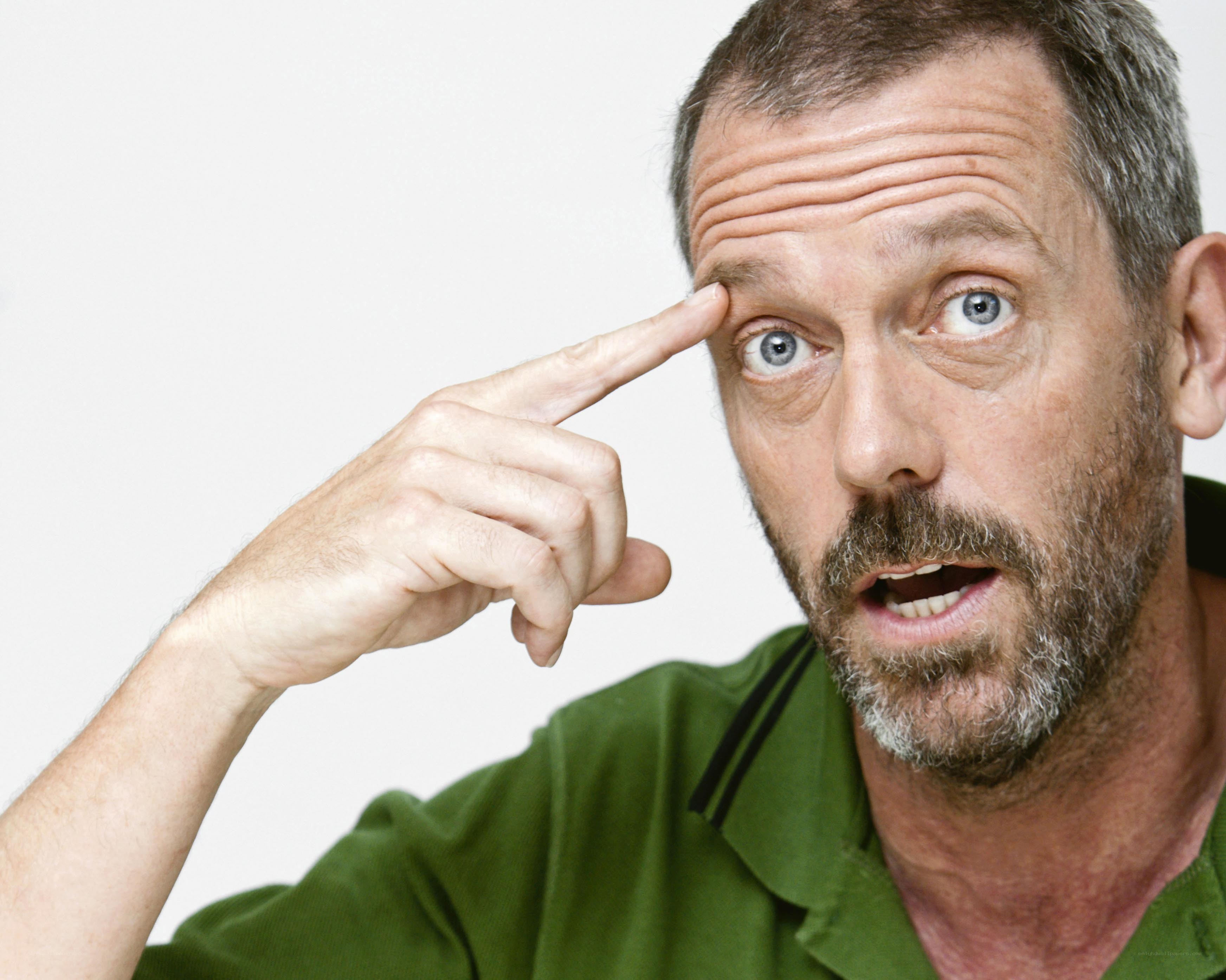 man pointing to forehead
