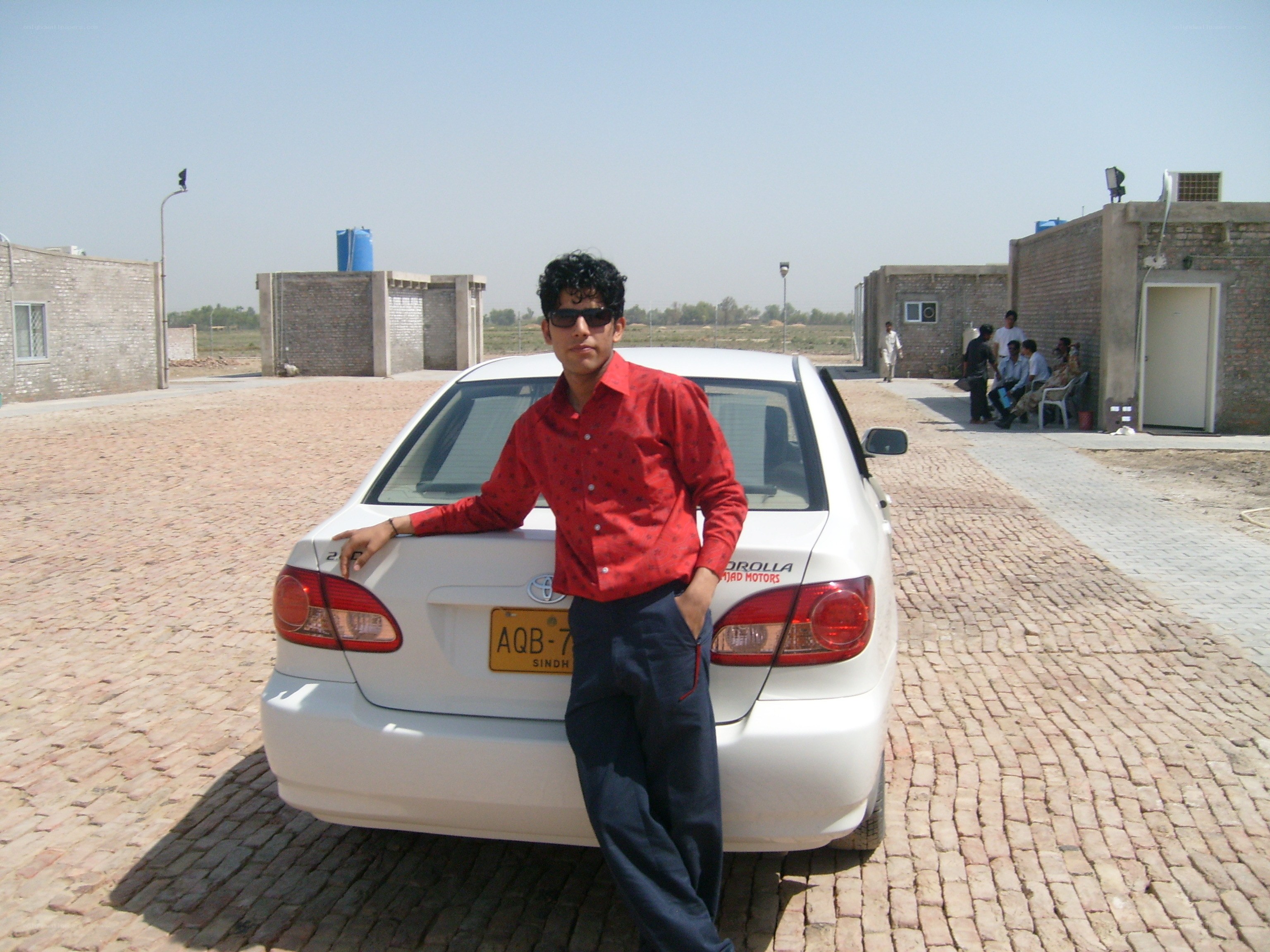 man posing with car