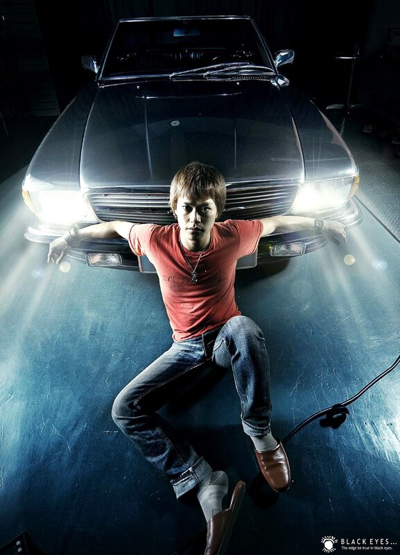 man posing with car