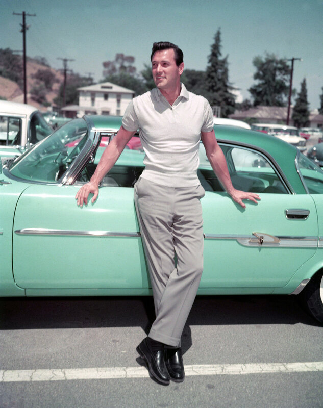 Man posing with vintage car