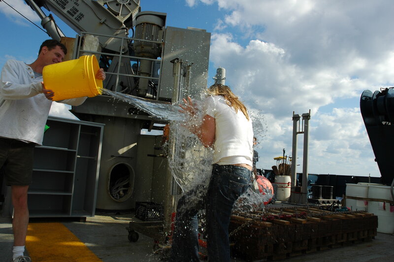 Man pours water on woman