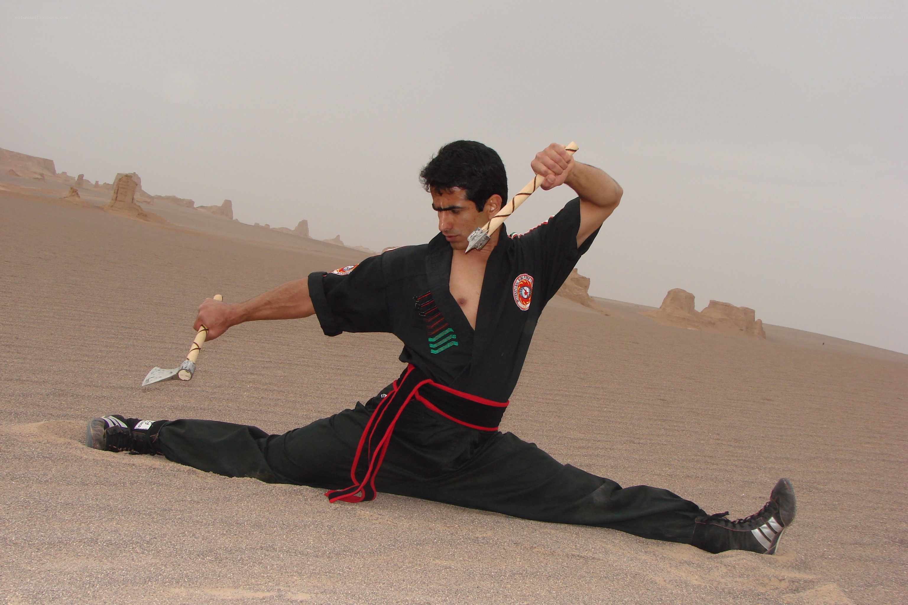 Man practicing martial arts in desert