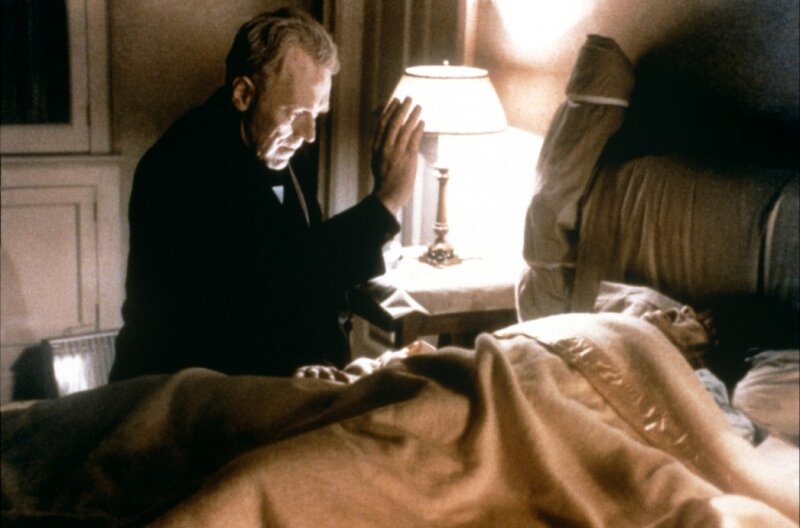 Man Praying at Bedside