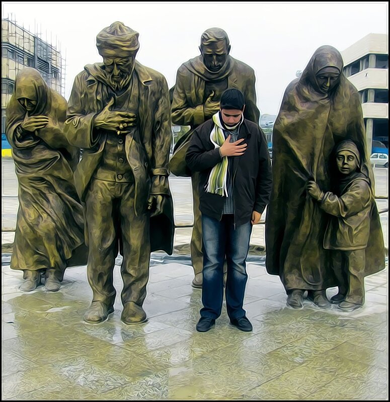 Man praying at statue