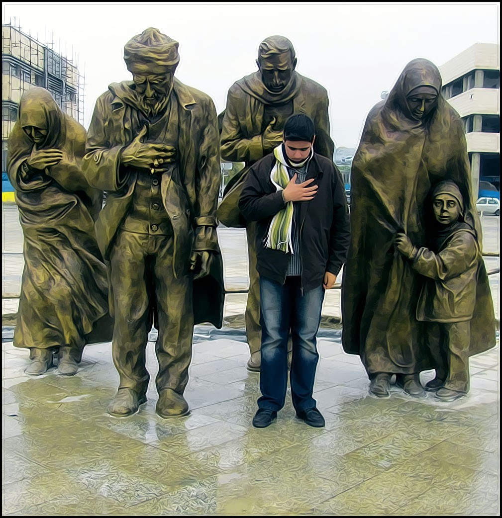 Man praying at statue
