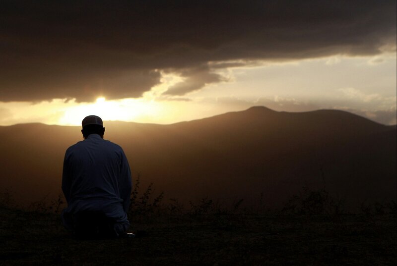 Man Praying at Sunset — Brown, Dramatic