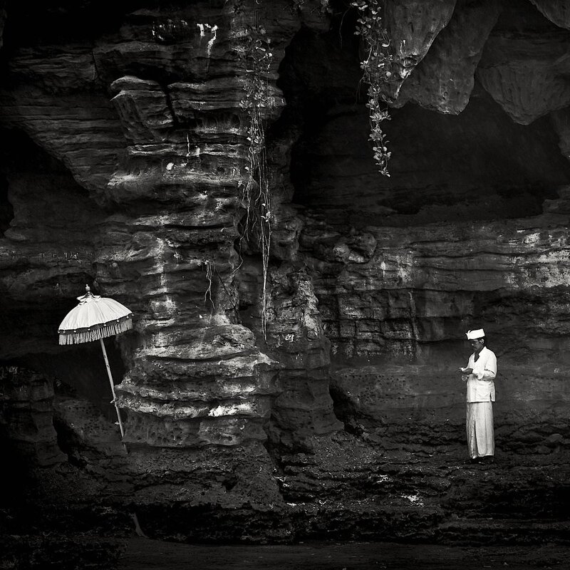 Man praying in a cave