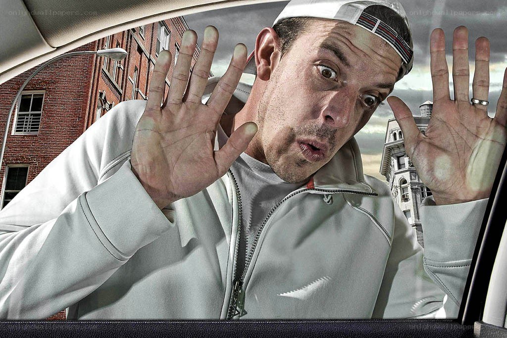 man pressing hands against car window