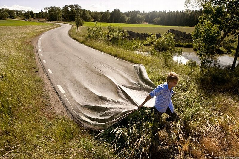 man pulling road fabric