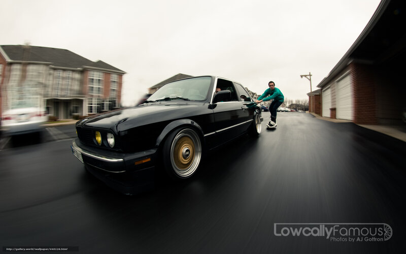 man pushing black car