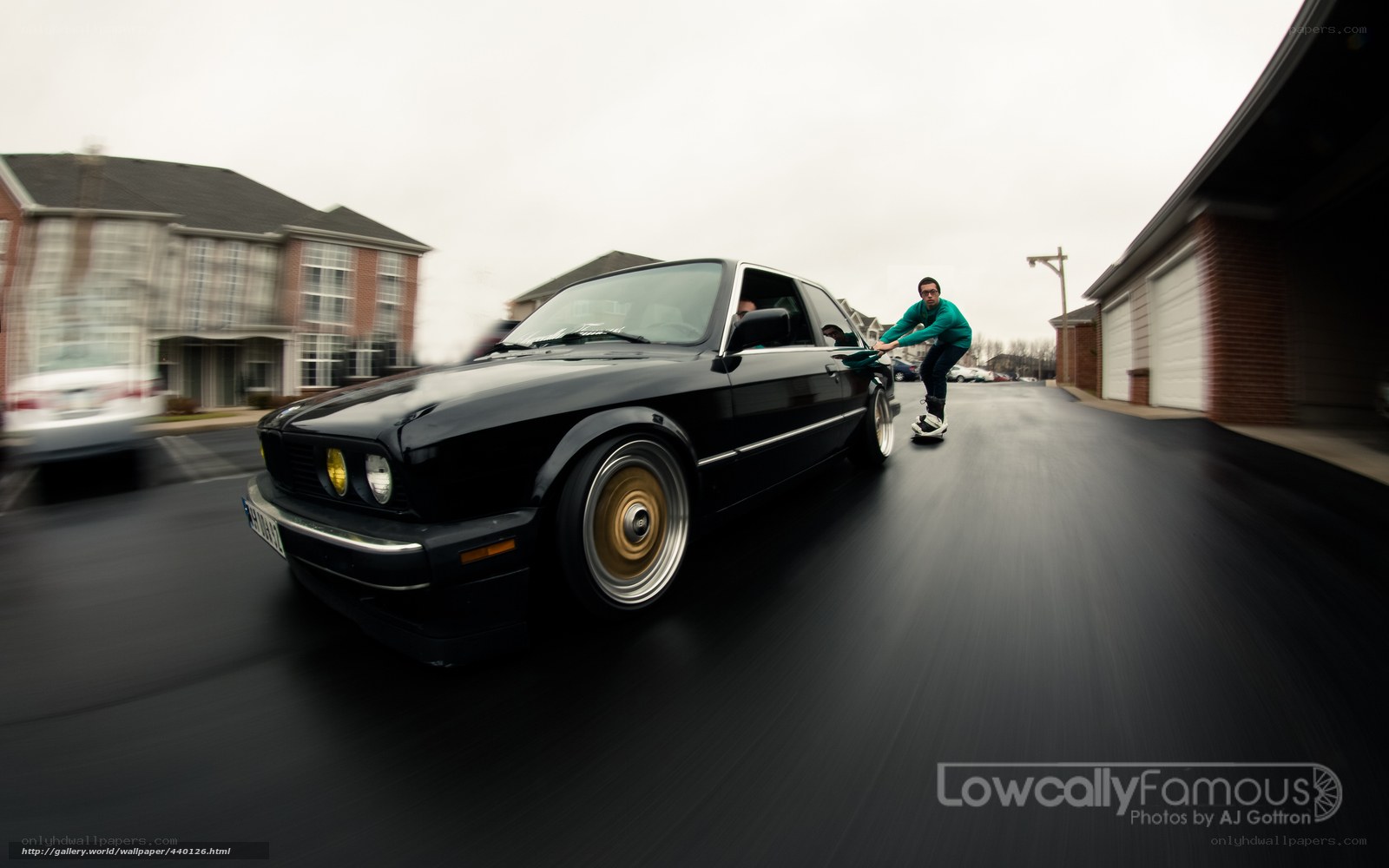 man pushing black car