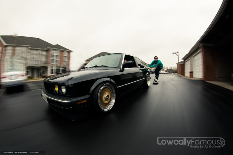 man pushing black car