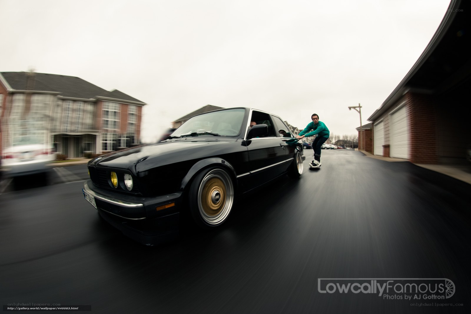 man pushing black car
