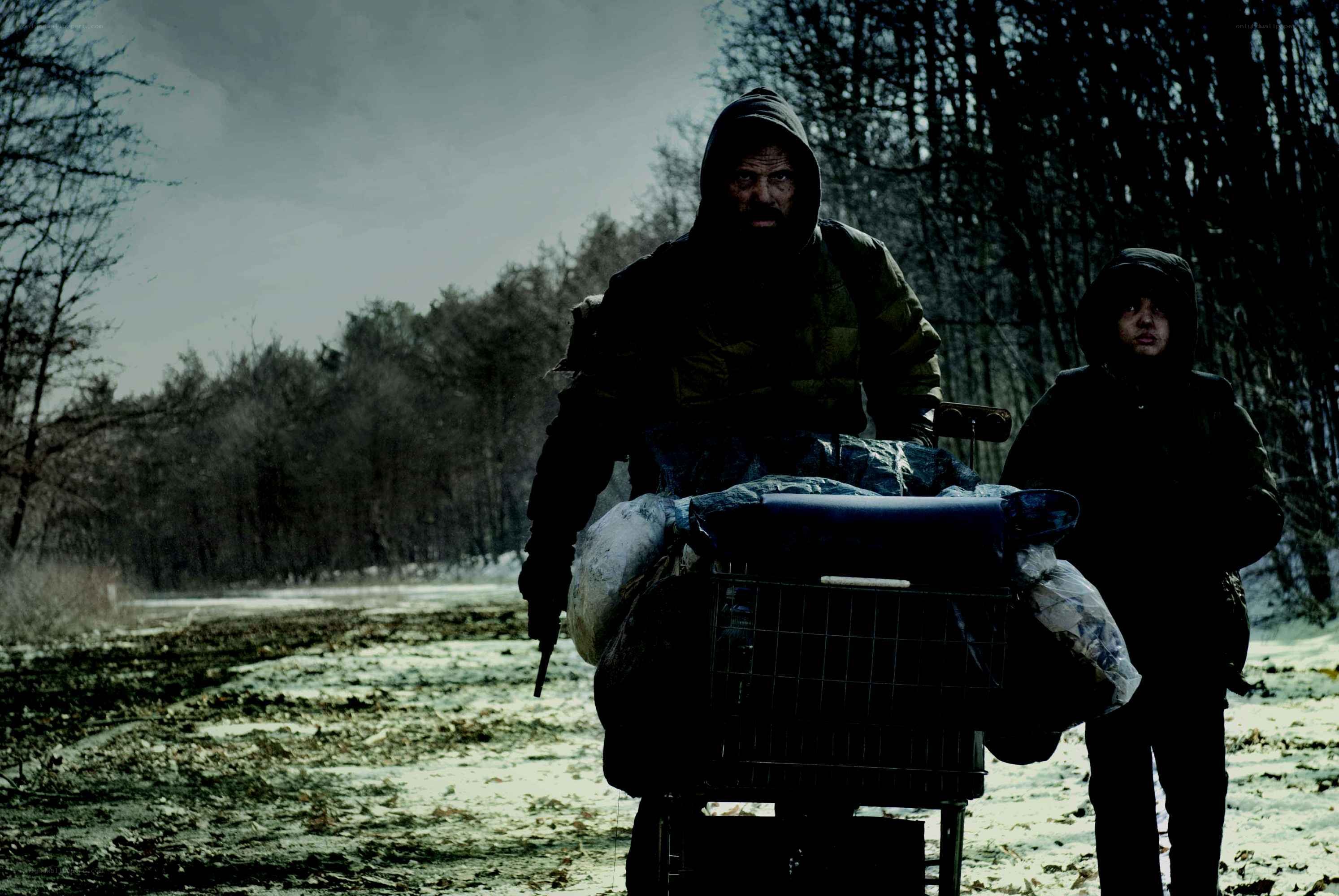 Man pushing cart with child
