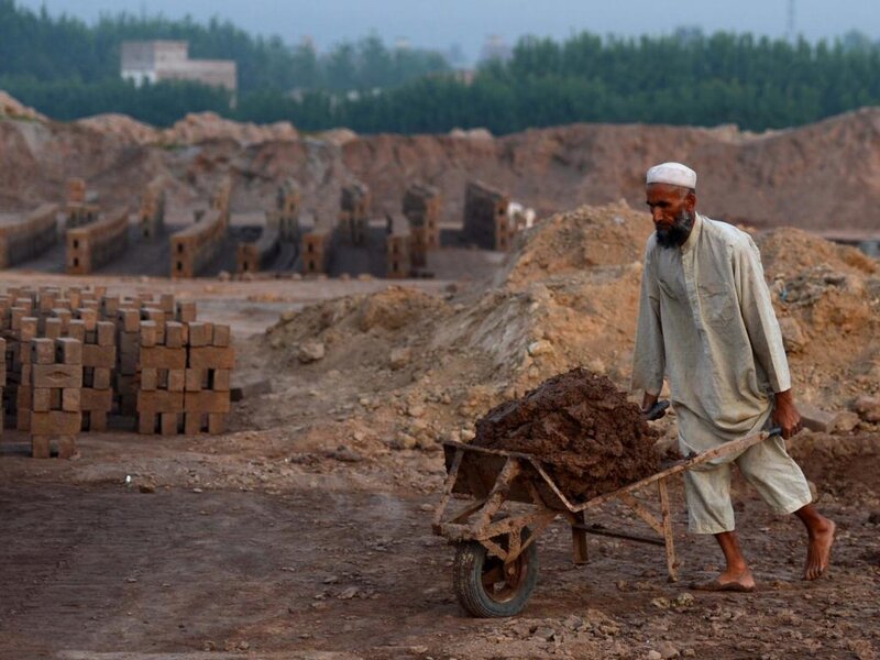 Man Pushing Wheelbarrow — Brown