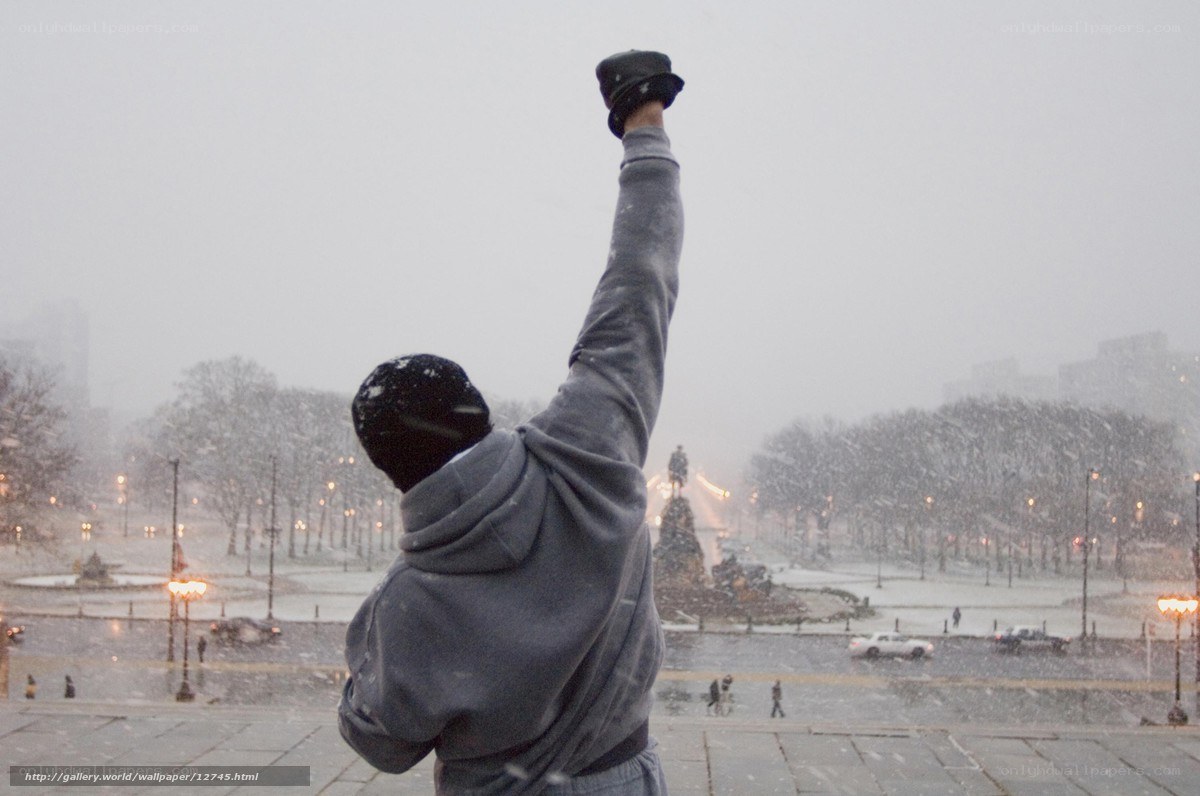 man raising fist in snow