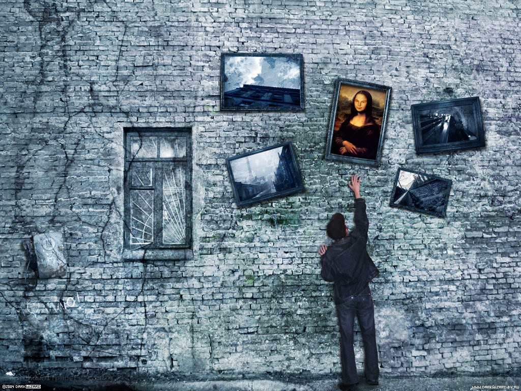 man reaching for paintings on wall