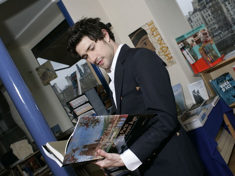man reading book in bookstore