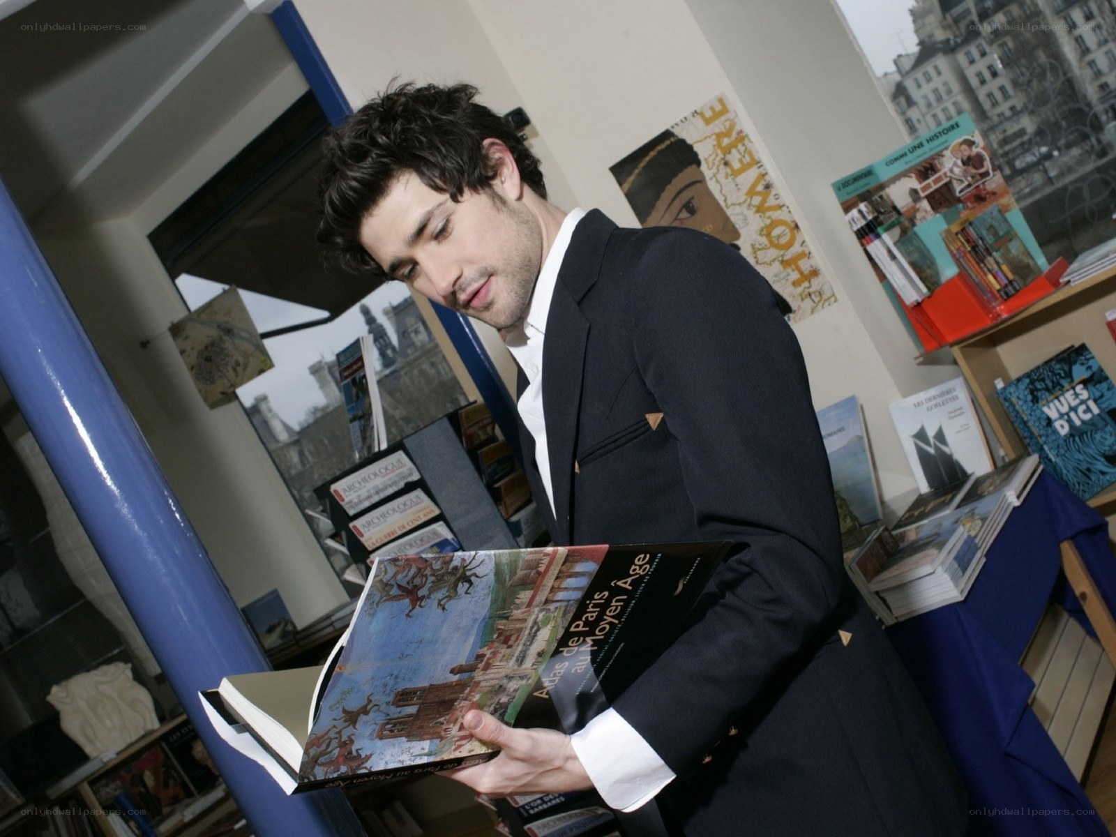 man reading book in bookstore