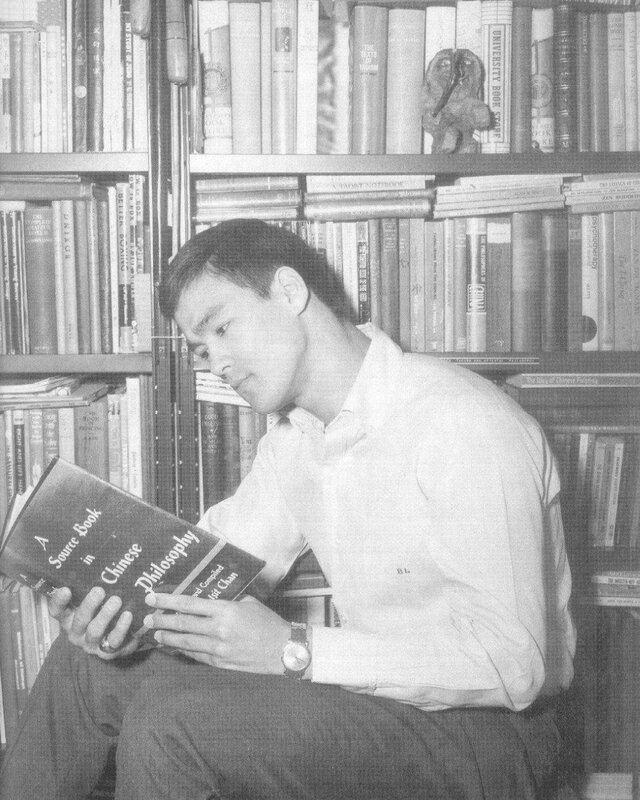 man reading book in library