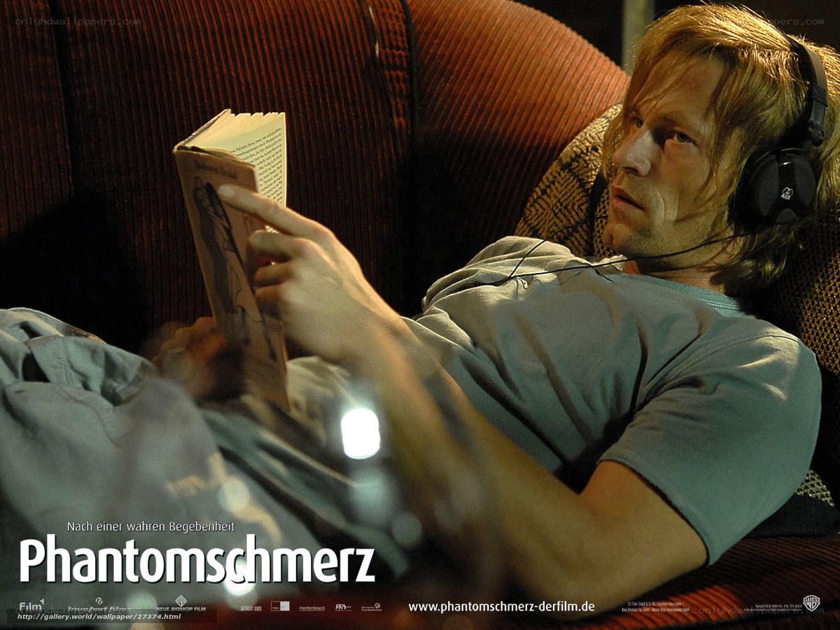 man reading book on couch
