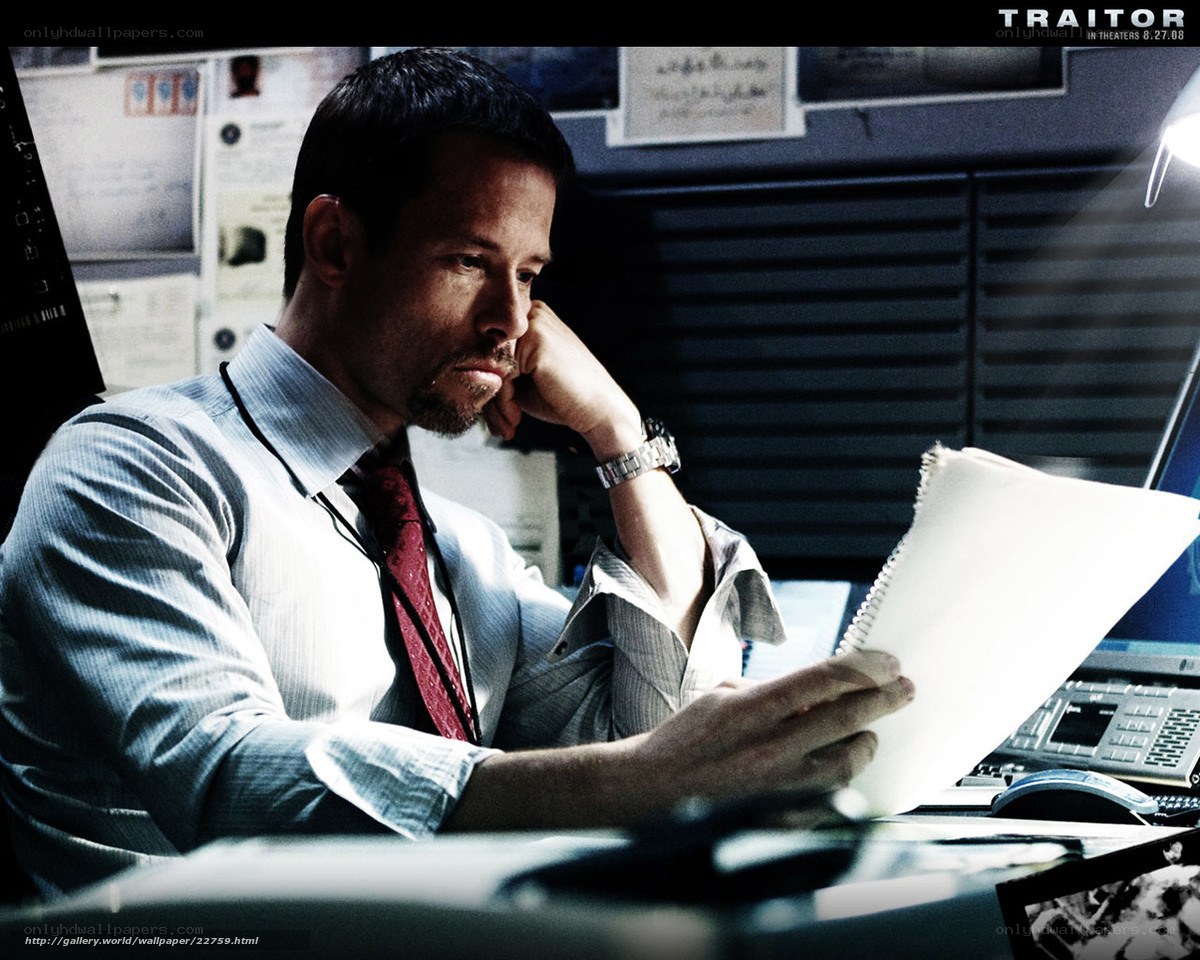Man reading documents at desk