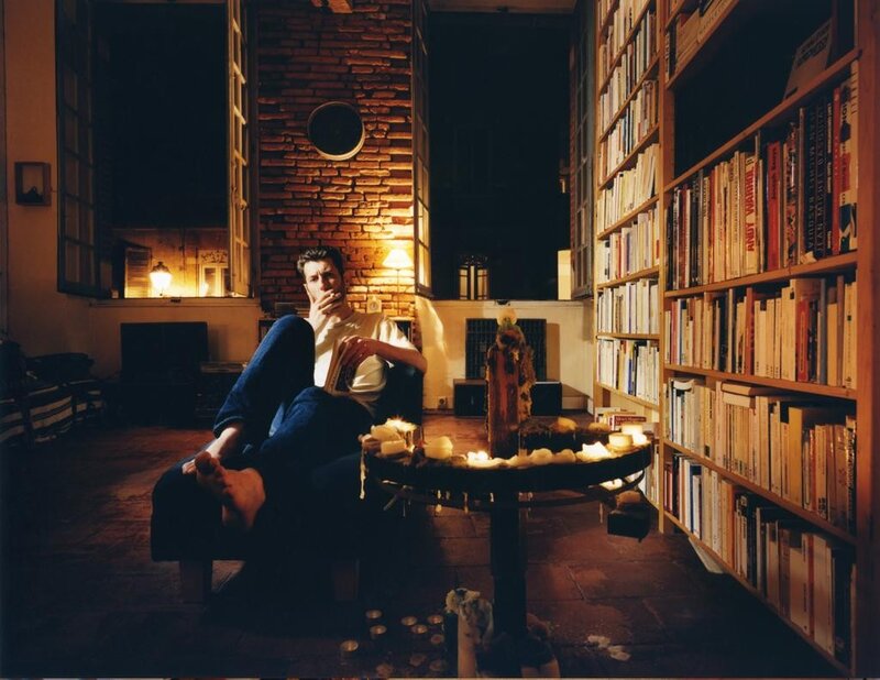 Man reading in a candlelit library