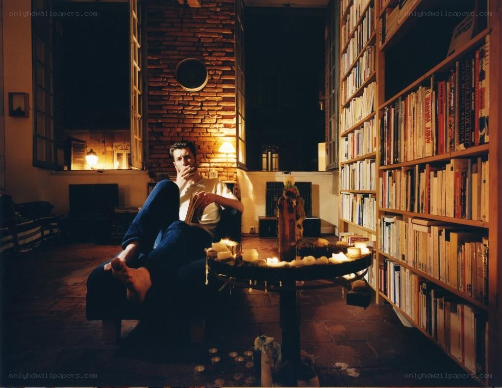 Man reading in a candlelit library