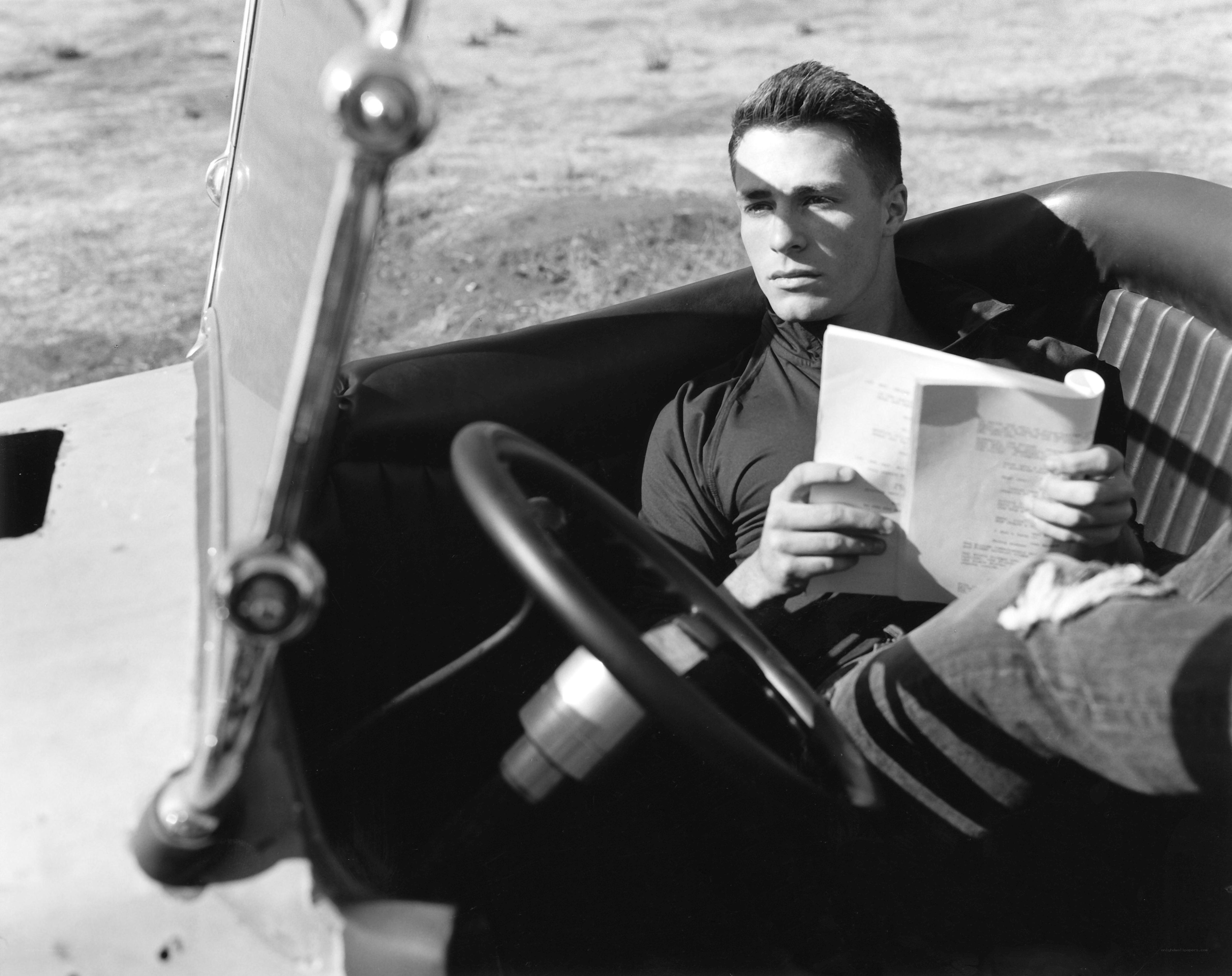 man reading in vintage car