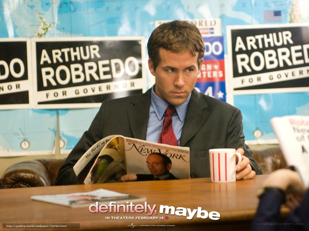 man reading magazine at desk