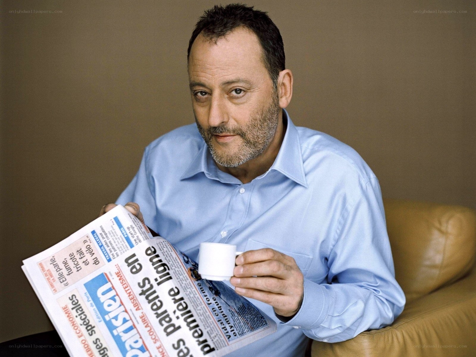 man reading newspaper and drinking coffee