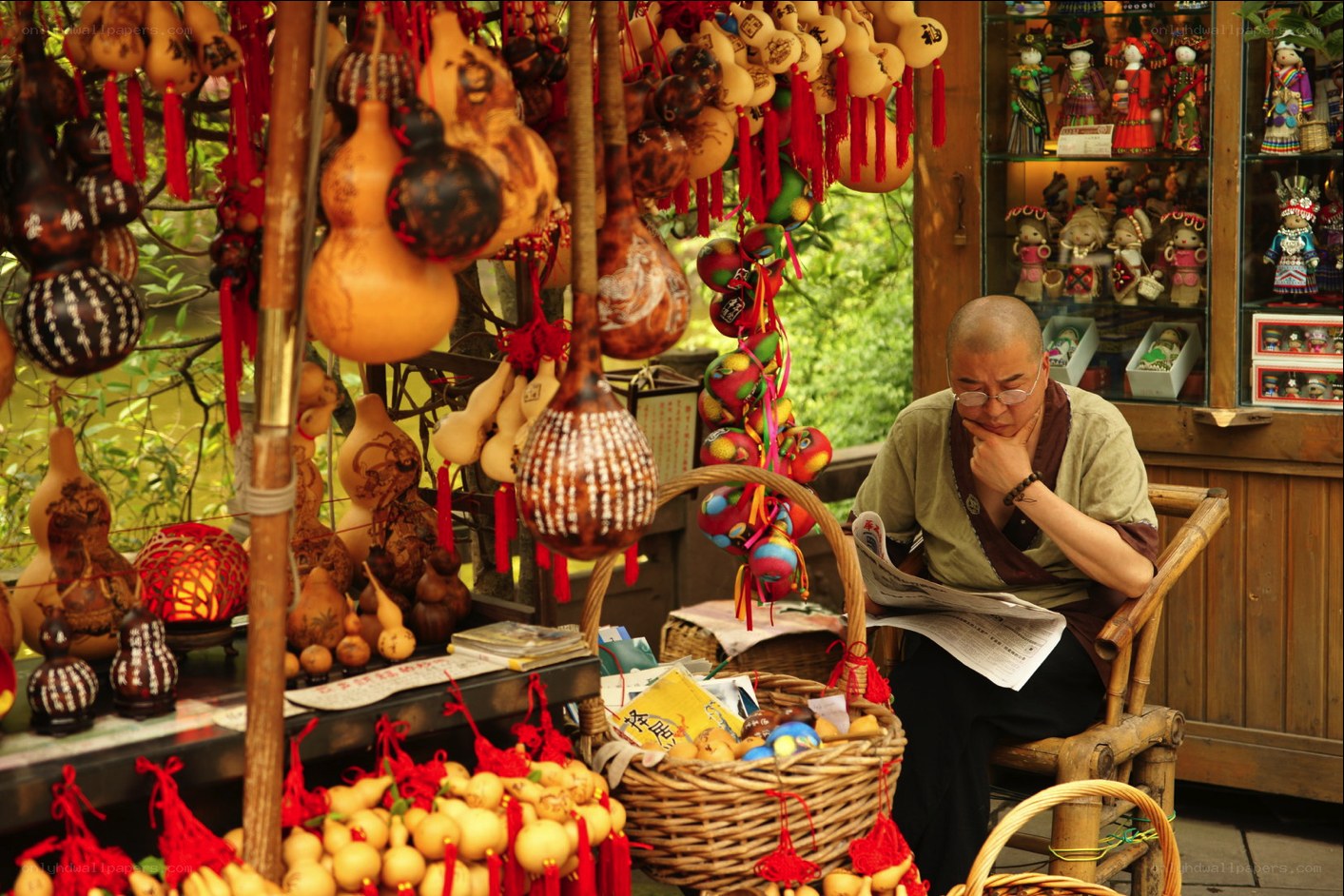 Man reading newspaper at market