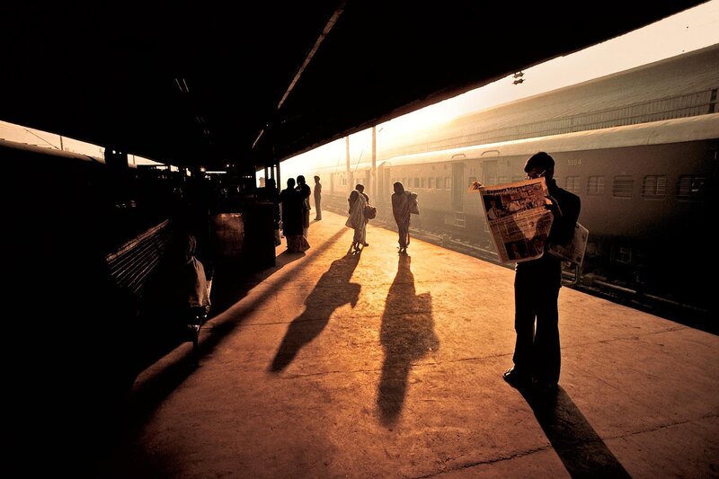 Man Reading Newspaper — Brown, Dramatic, Sunset