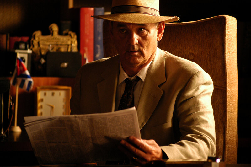 Man reading newspaper in office