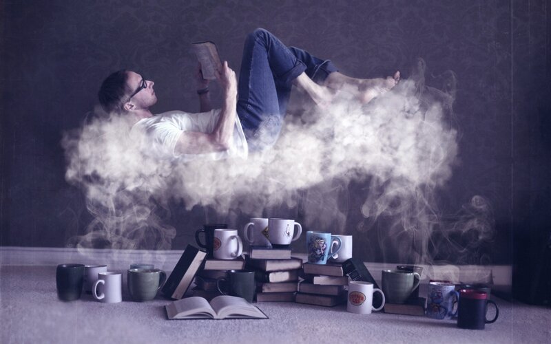 man reading on a cloud of steam