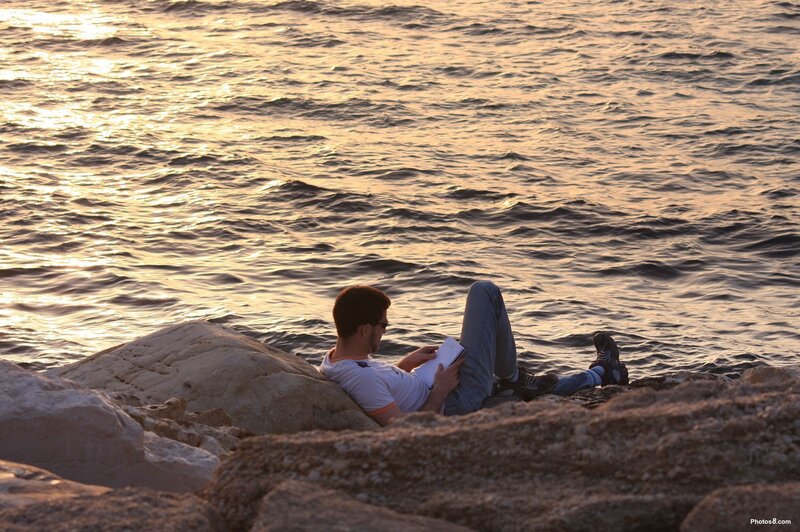 Man Reading on Rocks