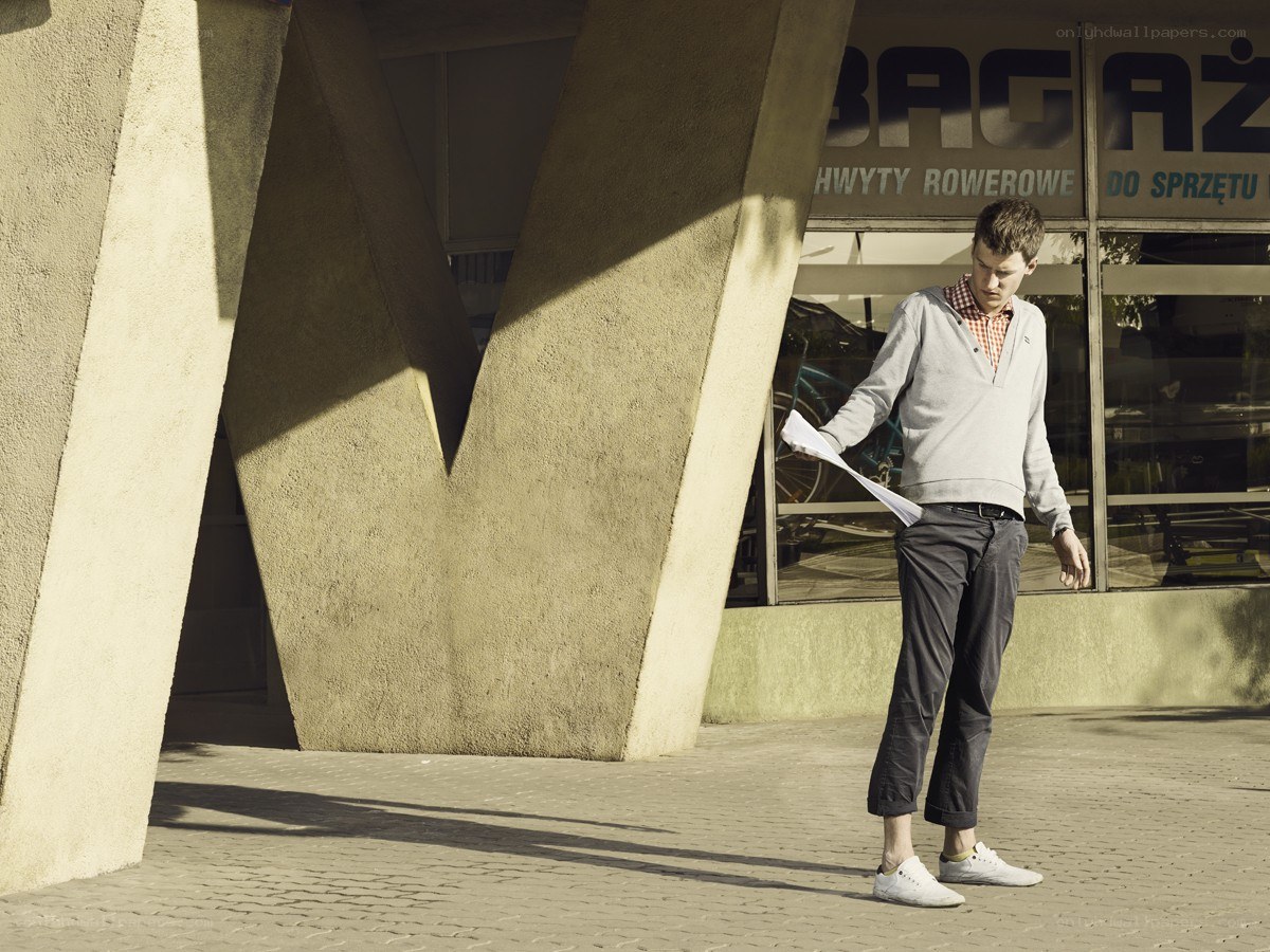 Man reading paper in urban setting