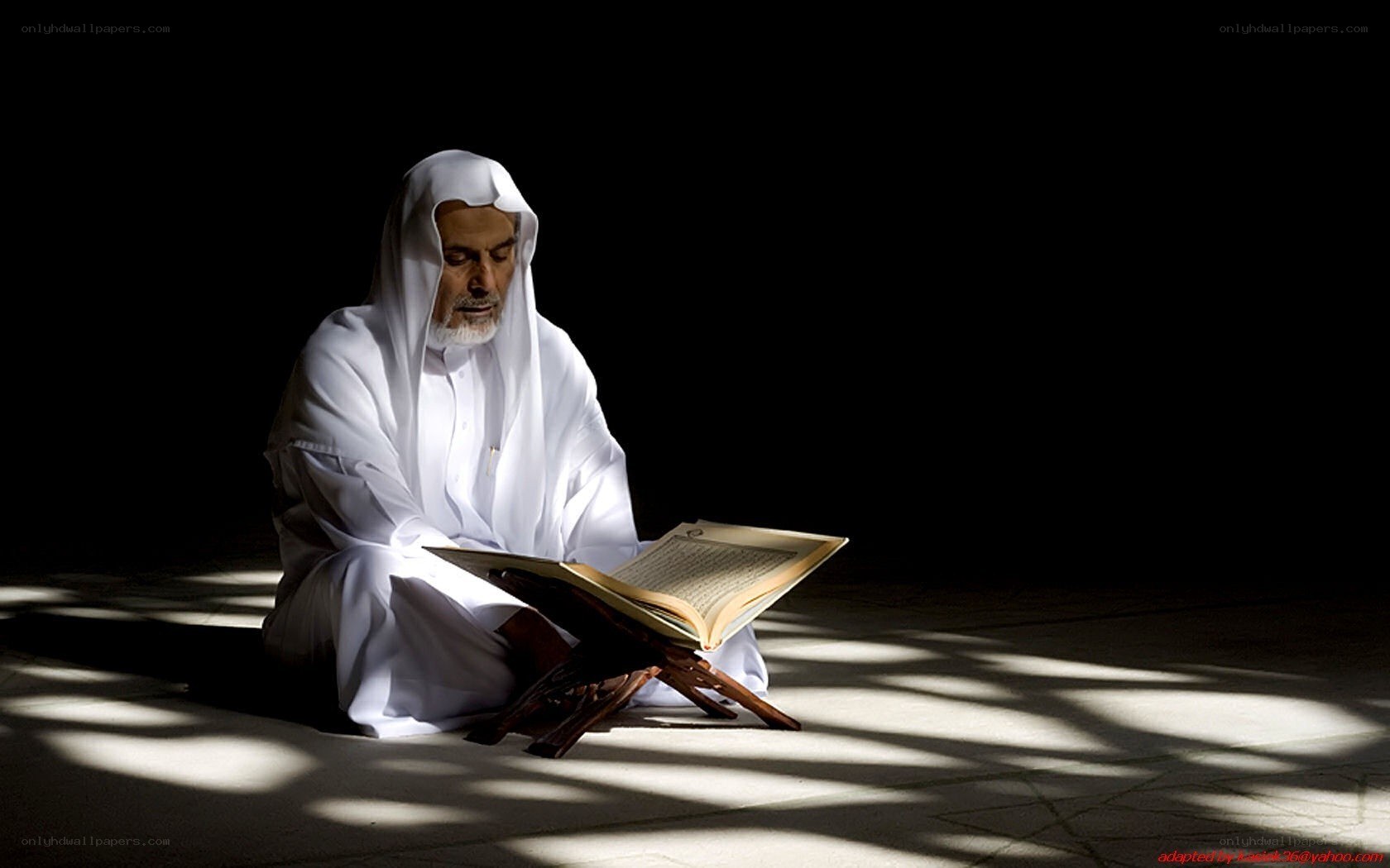 Man reading Quran in light