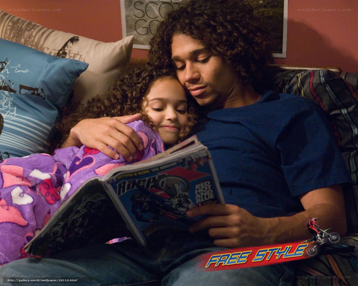 man reading to child on couch