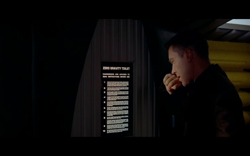man reading zero gravity toilet instructions