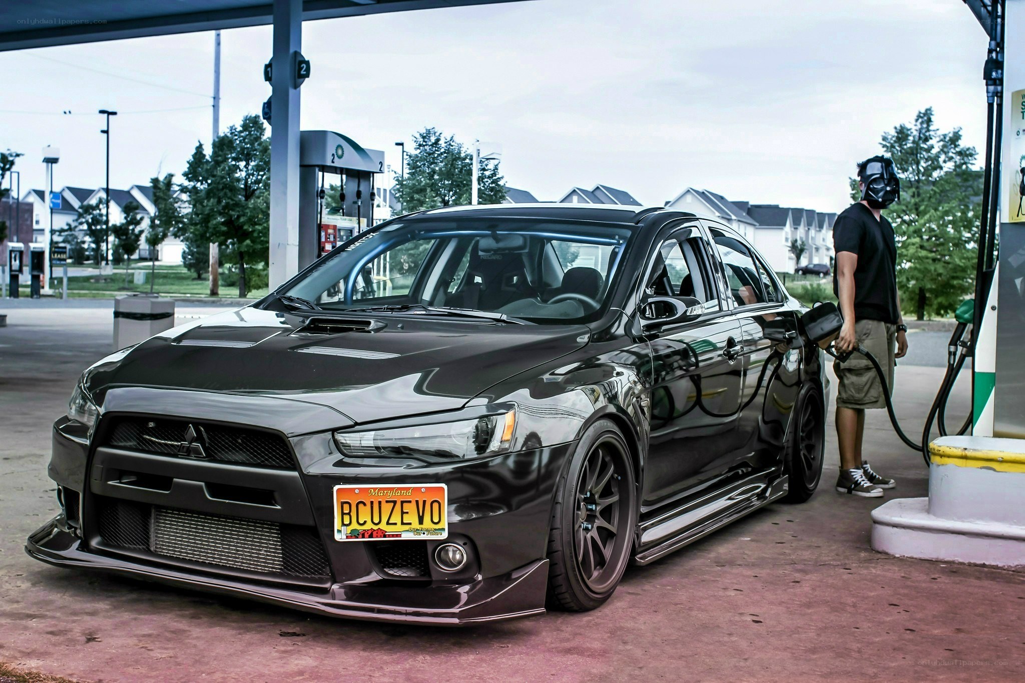 Man refueling black car