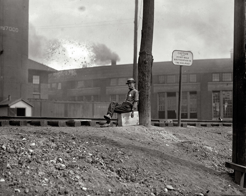 Man resting by railroad tracks