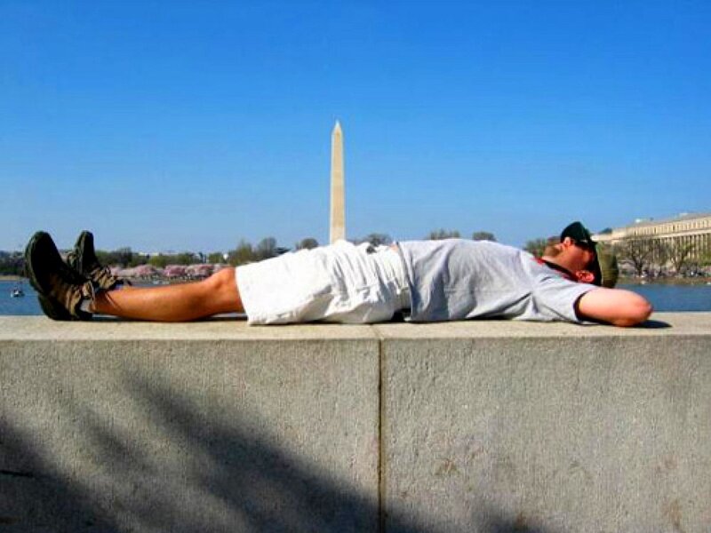 Man resting by the Washington Monument