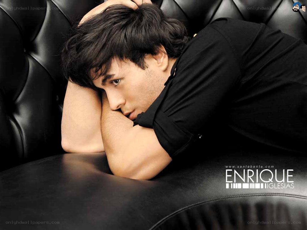 Man resting on black leather couch
