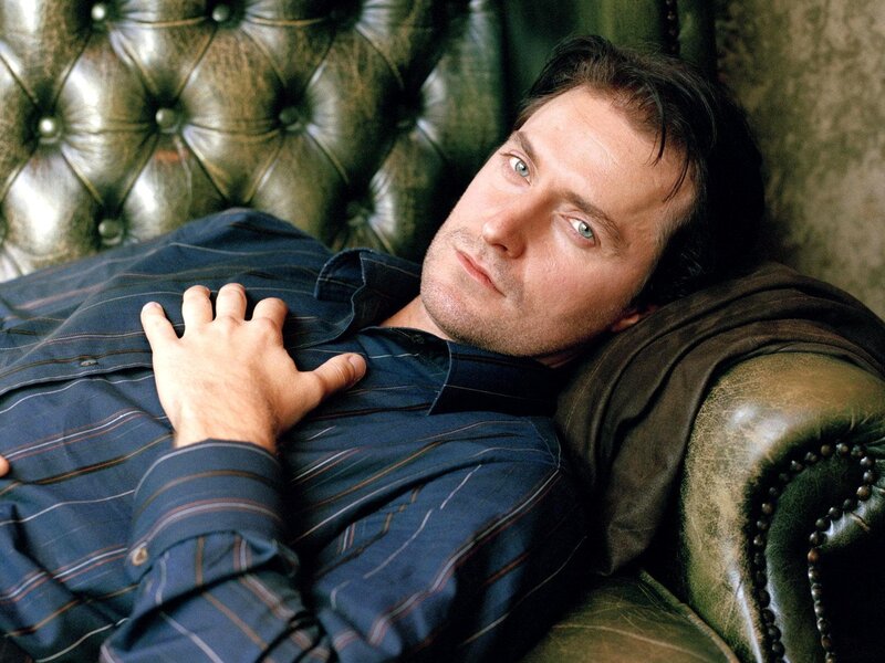 man resting on leather couch